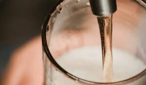 beer being poured into a glass