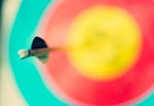 zoomed in focus of a dart in a dart board