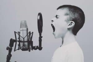 child singing into microphone