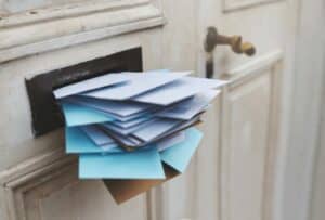 large stack of mail in a mail slot