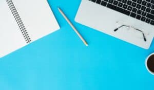 open notebook next to an open computer