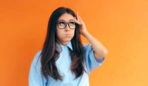 girl with glasses looking frustrated