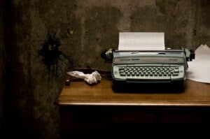 old typewriter sitting on wooden desk