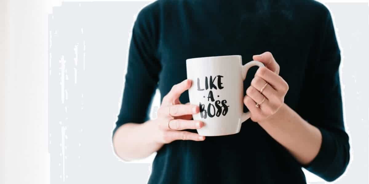 person holding a mug that says "like a boss"