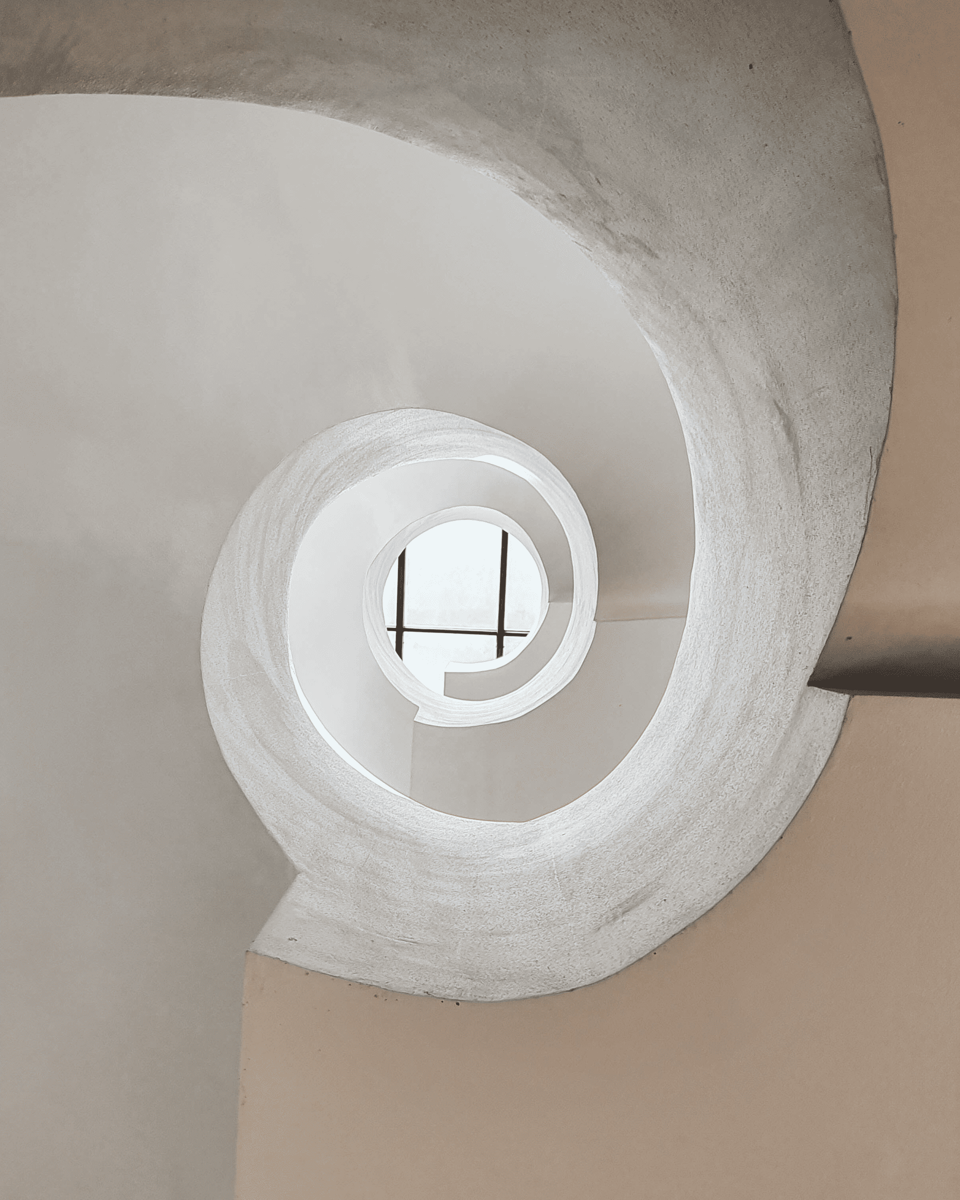 looking up in the middle of a spiral staircase