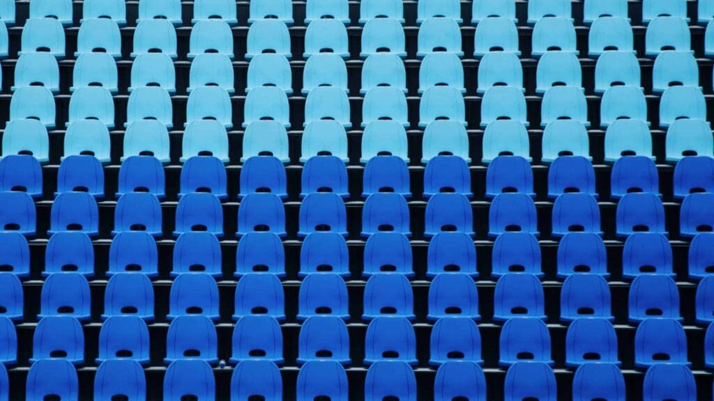 two color of blue stadium seats with no people in them