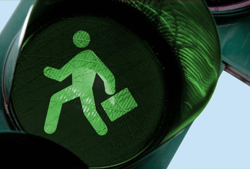 green light with a man with a briefcase outline in the middle