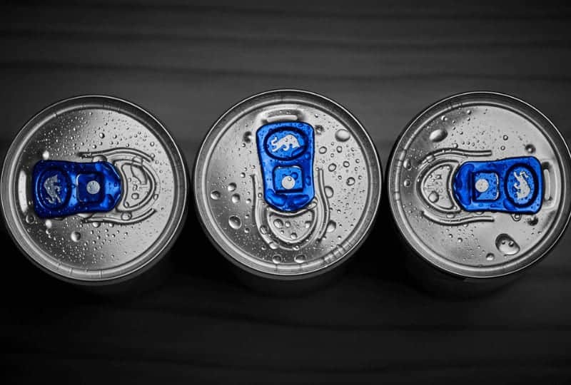 top view of three red bull cans