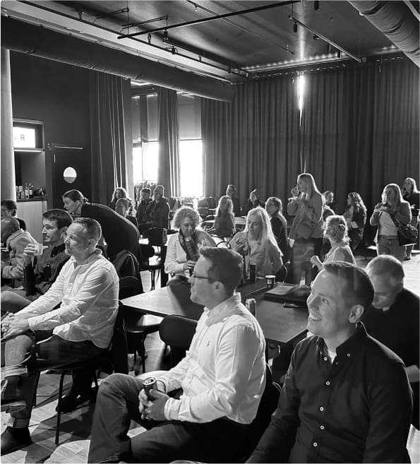 Black and white image of the audience at Iceland Innovation Week listening to a presentation by Madison Taylor Marketing CEO Aimee Meester.