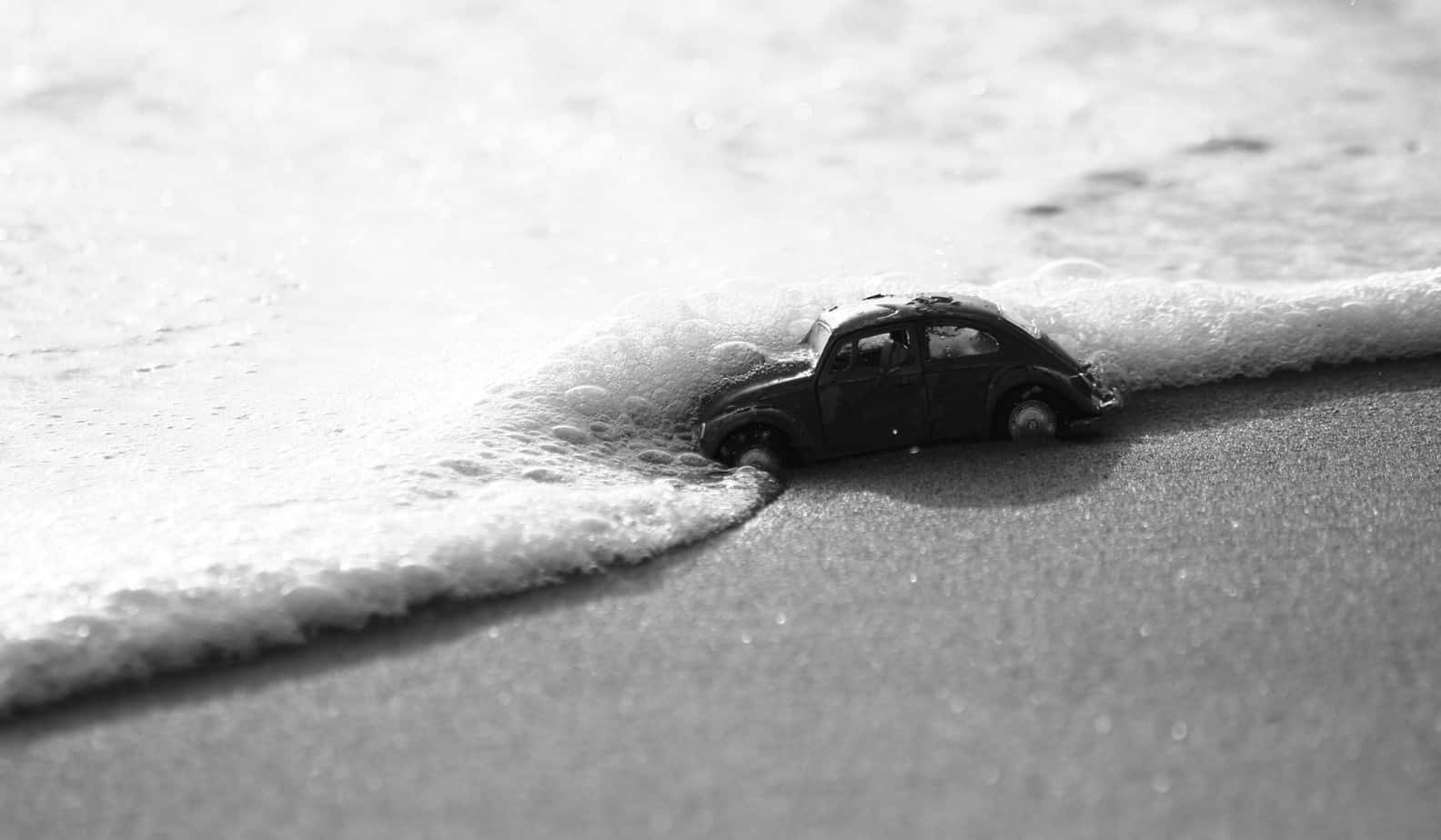 toy car on beach in tide