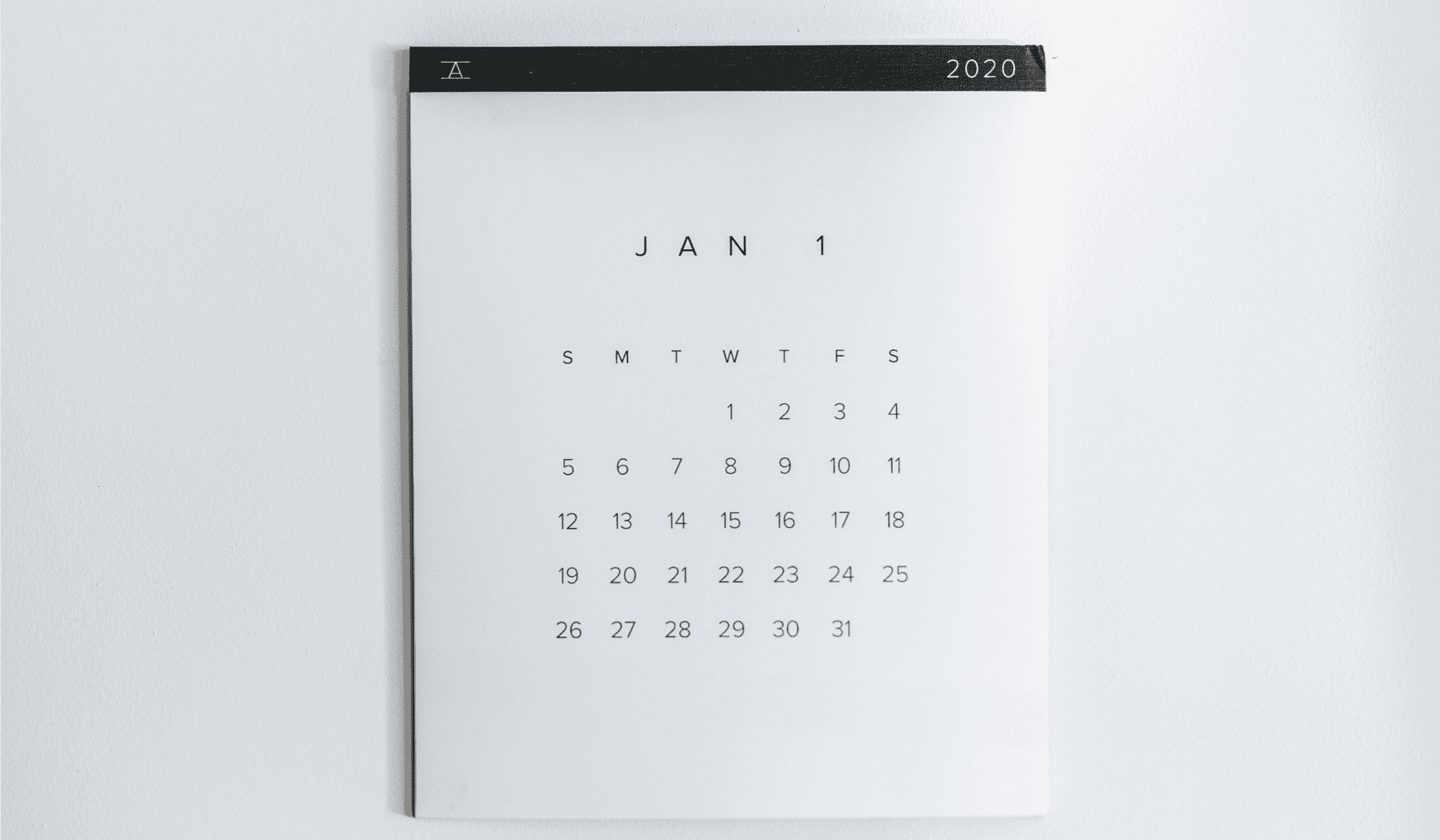 black and white image of January 1 calendar page on a white wall