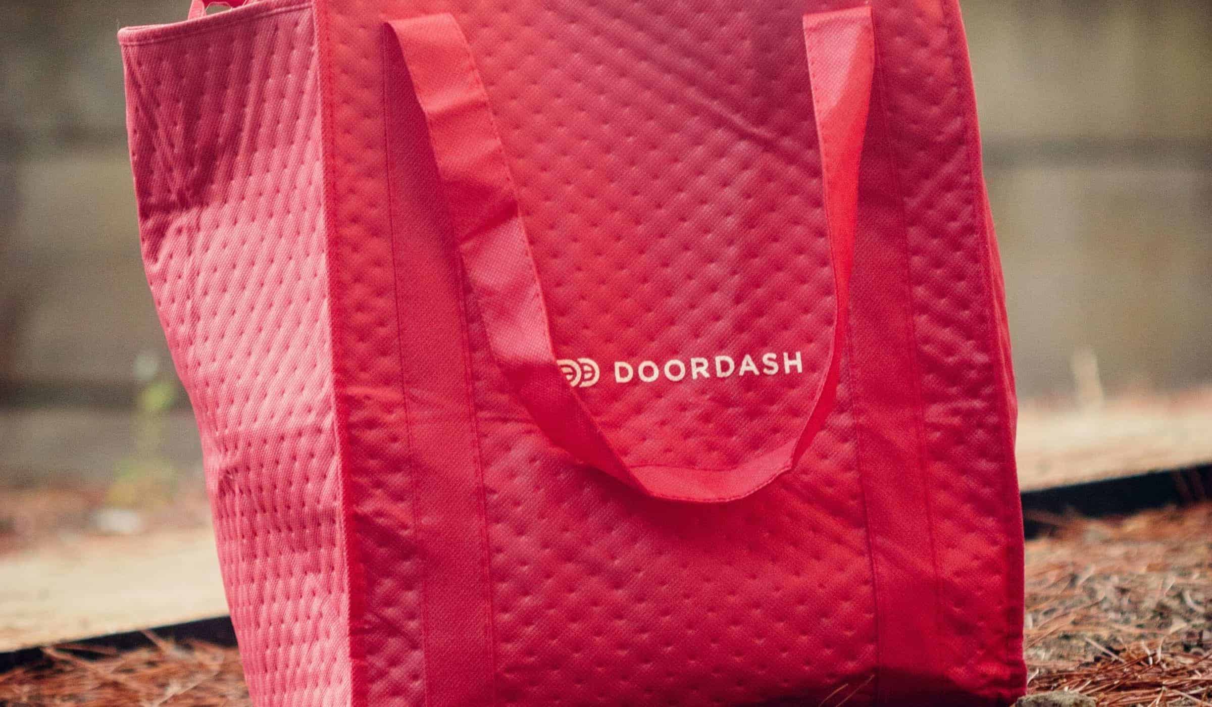 red bag with the "doordash" logo on the front