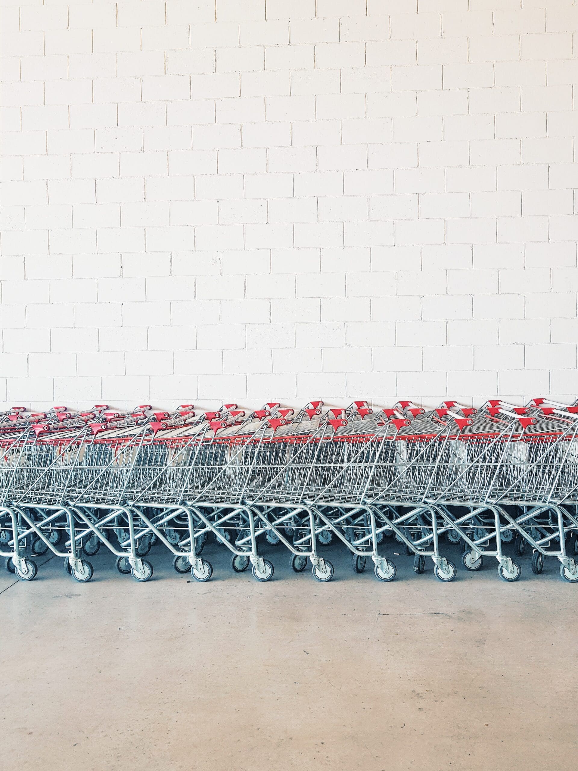 Shopping carts lined up representing the concept of pricing strategies.