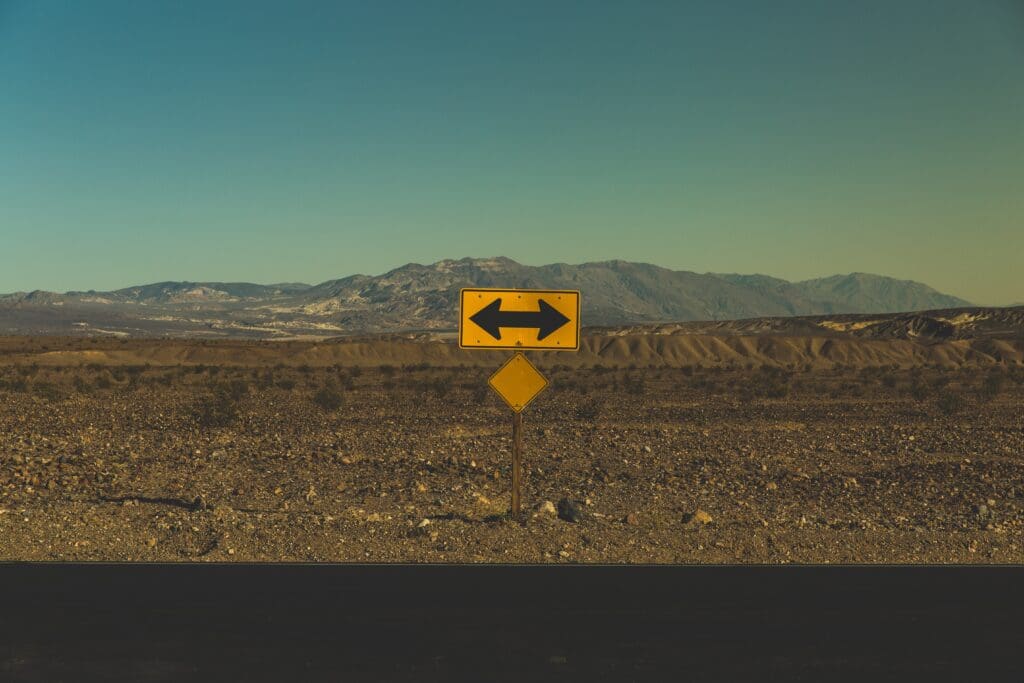 Double sided arrow sign in a desert