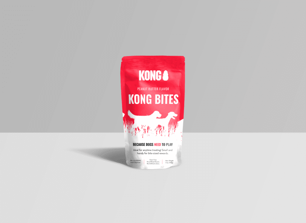 A sample of KONG dog bites in red packaging with white font sitting on a white table